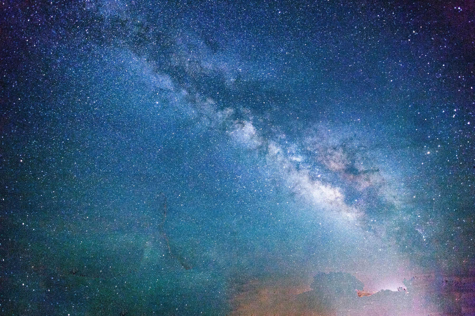 Night sky densely filled with stars and a visible Milky Way galaxy band.
